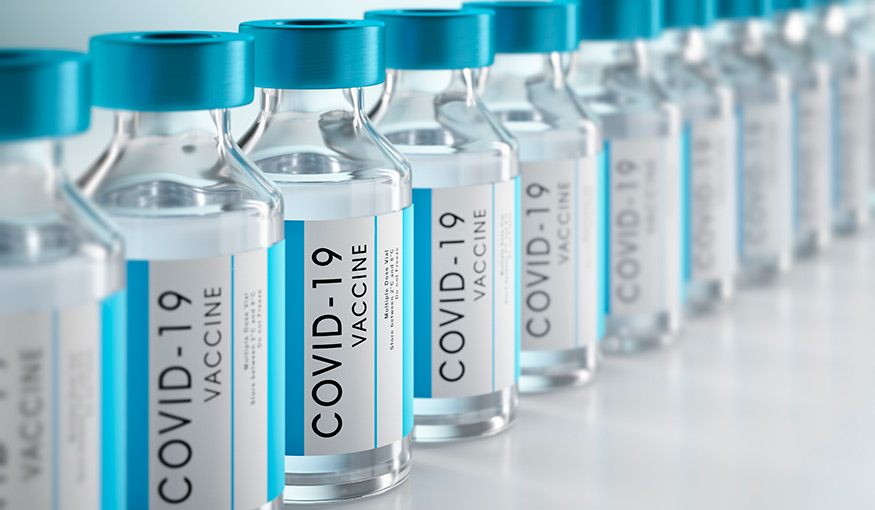 Doses of COVID-19 vaccinations are lined up in labeled bottles