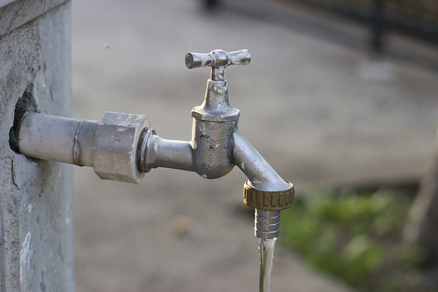 Image of water pouring from an outdoor faucet