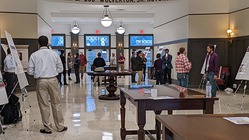 Spectators gather to view several of the participants’ posters during the recent Graduate Student Research Symposium in MSU’s Old Main Academic Center. (Photo submitted)