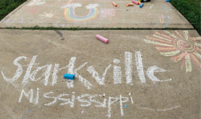 Sidewalk with the words "Starkville Mississippi" written in chalk