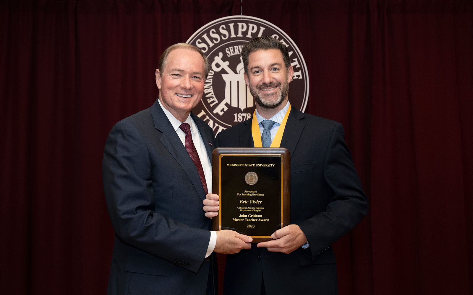 MSU President Mark E. Keenum congratulates Associate Professor of English Eric Vivier, the university’s newest Grisham Master Teacher. 