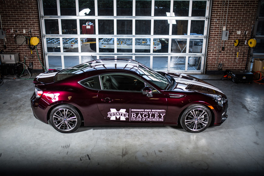 The Car of the Future’s innovative technologies are framed in a distinctive paint job performed by Clinton Body Shop, featuring custom Kandy maroon and ice white pearl colors by House of Kolor. The lighter, greener hybrid vehicle offers over 100 miles of driving using the equivalent of a single gallon of gas. (Photo by Hunter Hart)