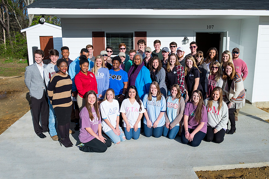 MSU’s Office of Fraternity and Sorority Life dedicated a Habitat for Humanity home at 107 Owens Lane in Starkville to Annie Hopkins (center) on Wednesday [March 2]. Greek organizations raised $75,000 to fully fund the project. (Photo by Russ Houston)