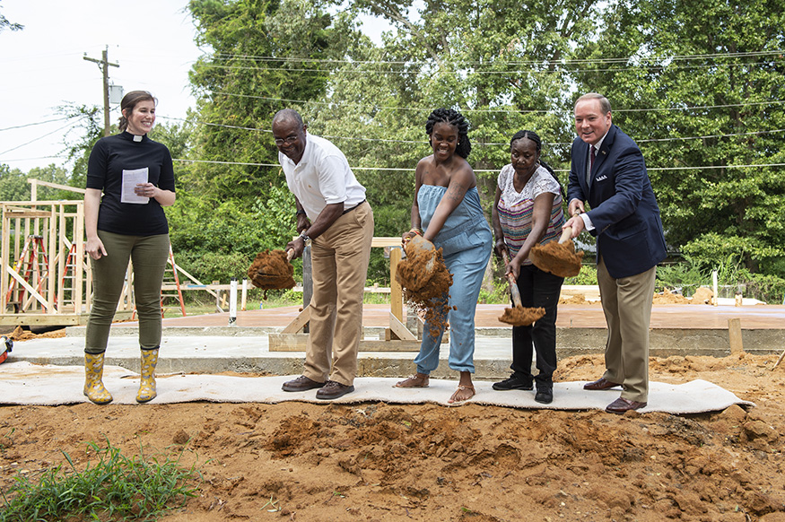 Rev. Sarah Jo Adams-Wilson looks on during the groundbreaking for the 10th Maroon Edition Habitat for Humanity home. Digging in to get the construction started are, from left, Starkville Area Habitat for Humanity President Charles Ware, Habitat partner Lou-Quan Lucious and her grandmother Gracie Jones, and MSU President Mark E. Keenum. (Photo by Logan Kirkland)