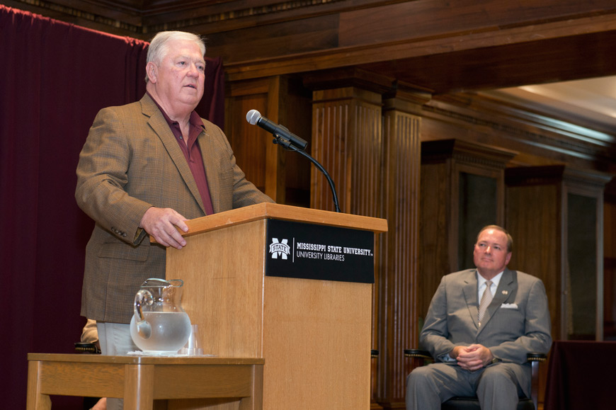 MSU President Mark E. Keenum, right, looks on as former Mississippi Gov. Haley Barbour shares stories of sacrifice and courage exhibited by Mississippians and others from around the country in response to Hurricane Katrina. The Yazoo City native’s well-attended presentation was held Monday [Aug. 24] in Mitchell Memorial Library’s John Grisham Room.   (Photo by Megan Bean)