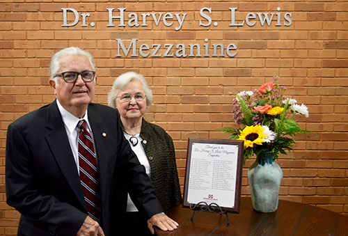 Dr. Harvey S. Lewis is pictured in this 2016 photo with his wife Dr. Di Ann Lewis at the Dr. Harvey S. Lewis Mezzanine on the second floor of the Seal Family Business Complex atrium in McCool Hall. (Photo by Addie Mayfield)