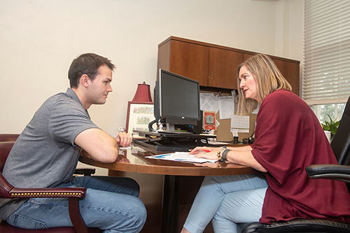 Mary Celeste Reese, director of MSU’s Dr. A. Randle and Marilyn W. White Health Professions Resource Center, advises a student in the Harned Hall office.