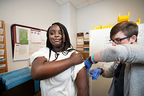 MSU Longest Student Health Center Charge Nurse Allison Townsend gives a shot to a patient.