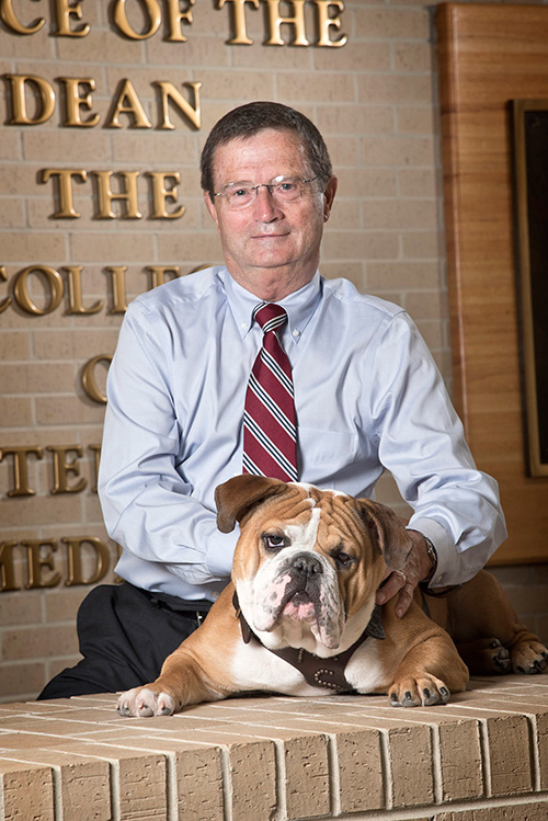 Portrait of Dr. Kent Hoblet with MSU's bulldog mascot