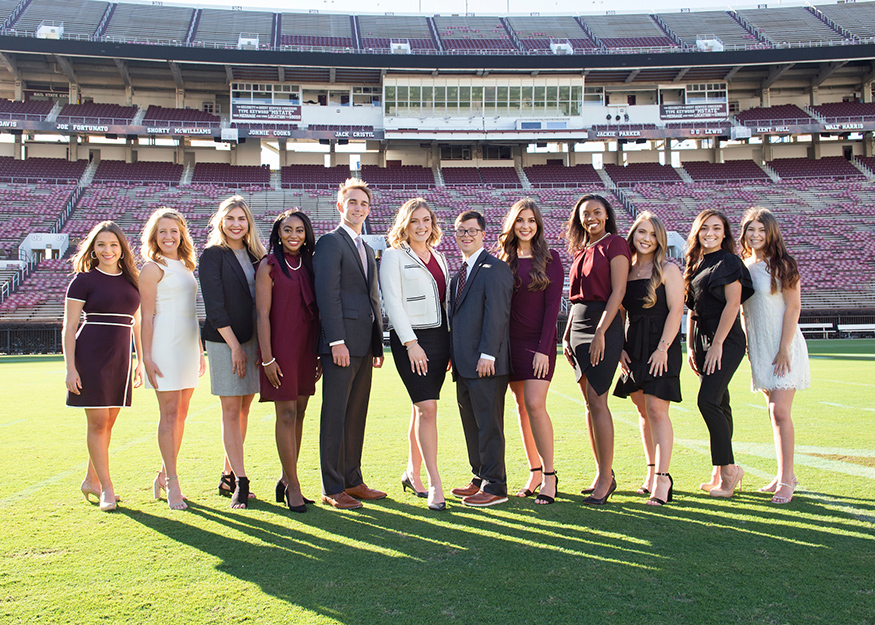 MSU’s 2019 Homecoming Court members smile for a group photo while standing on Scott Field inside Davis Wade Stadium.