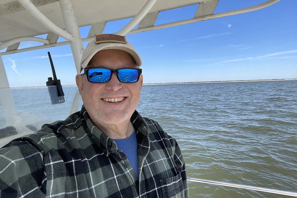 Jonathan Harris, pictured on a boat with the ocean in the background