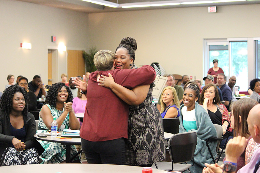 Research and Curriculum Unit project manager Leanne Long, left, hugs Maria Tarleton as she receives the Most Improved Award for the 2017-2018 New Teacher Induction cohort. Tarleton teaches at the Claiborne County Vocational and Technical Complex in the Claiborne County School District. (Photo by Carl Smith)
