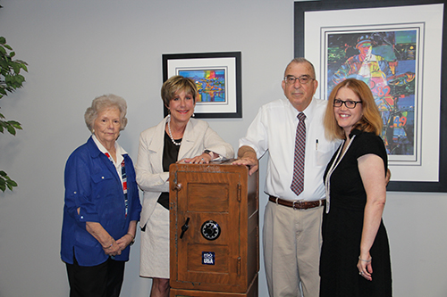 From left, MSU Dean of Libraries Frances Coleman, College of Business Dean Sharon Oswald, former faculty member and university administrator George Verall, and Finance and Economics Department Head Kathleen Thomas, pose with the safe that contained a collection of antique money Verrall collected in the 1970s. (Photo by Emily Daniels)