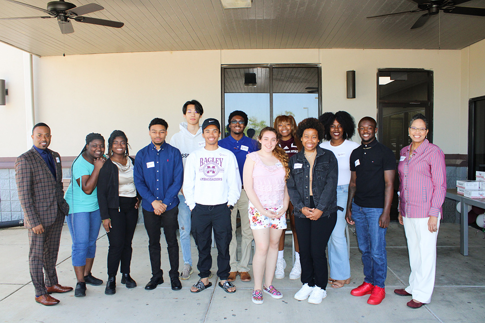 A picture of a group of students standing together outside a building.  