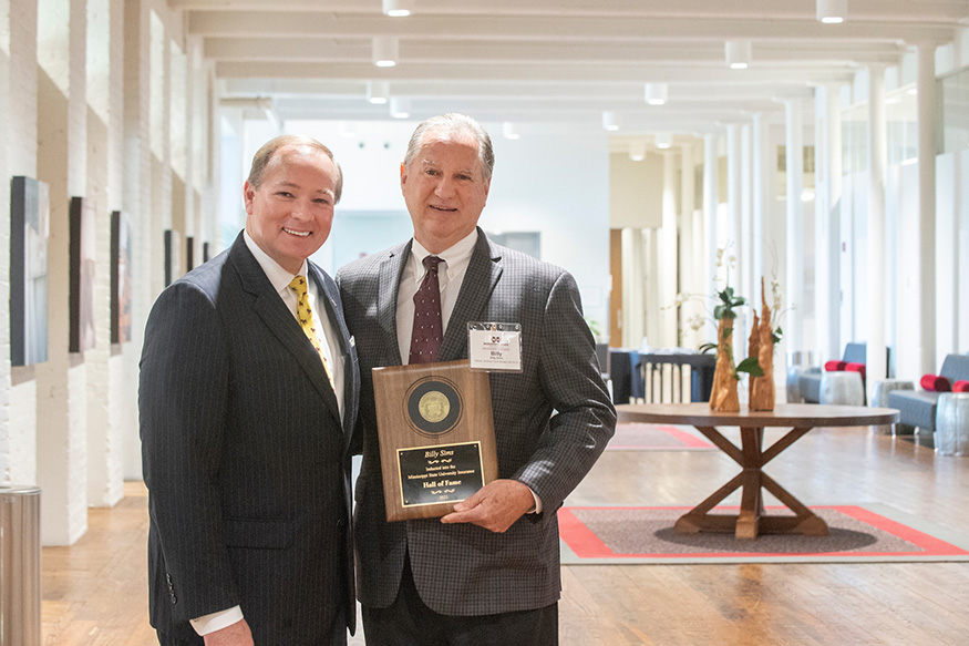 MSU President Mark E. Keenum, left, is pictured with retired Southern Farm Bureau Life Insurance Company executive Billy Sims of Brandon. 