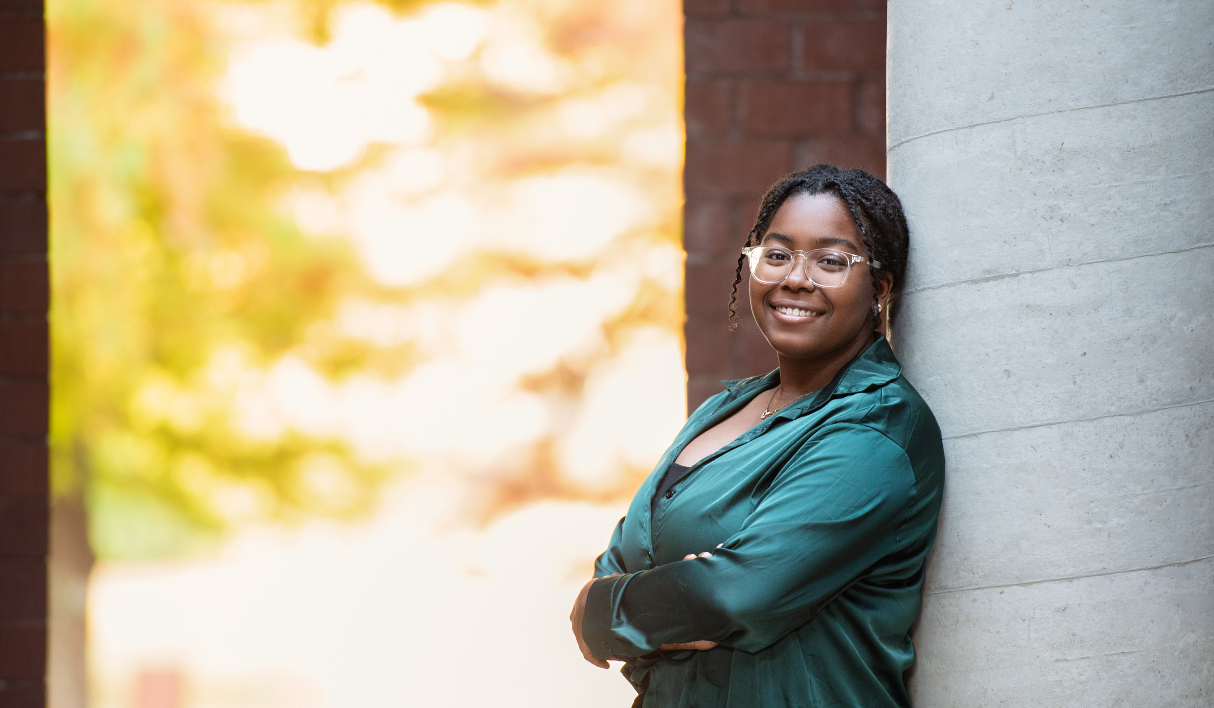 Ania Issac, pictured next a brick wall at the Social Science Research Center.