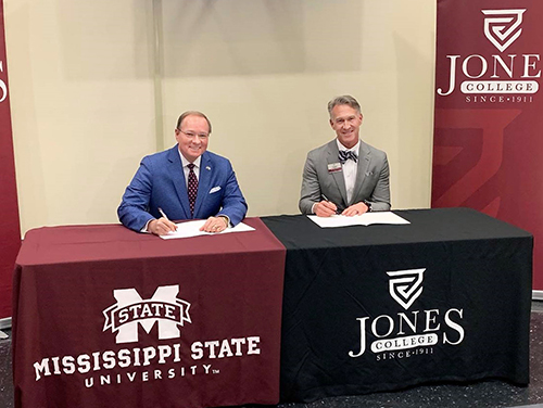 Mark Keenum and Jesse Smith sign an agreement at Jones College.