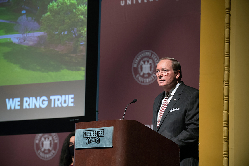 Mark E. Keenum speaks from a podium at the General Faculty Meeting.
