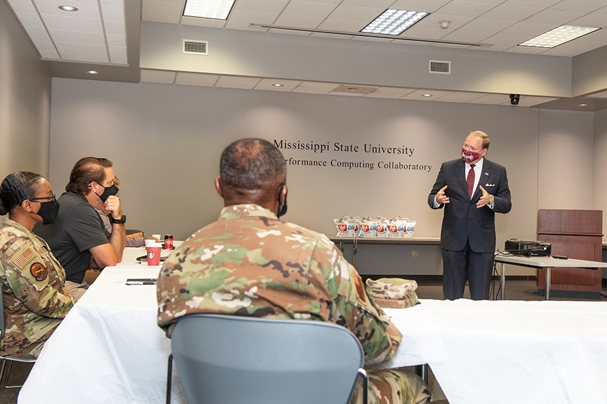 Mark Keenum speaks in a conference room with Keesler Air Force Base officials.