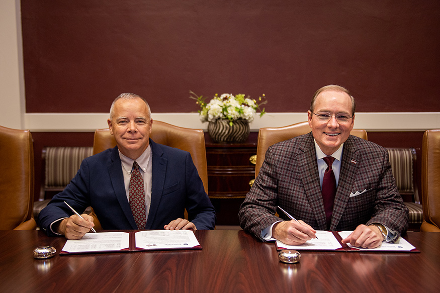 SBC President Scott R. Carson, left, and MSU President Mark E. Keenum sitting at a conference table for the agreement signing