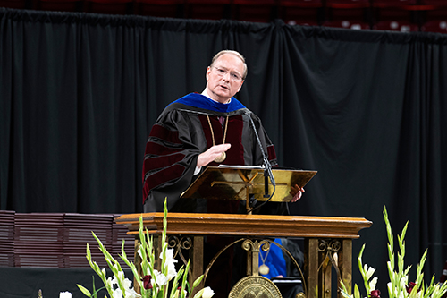 MSU President Mark E. Keenum wears graduation regalia and gives commencement remarks.