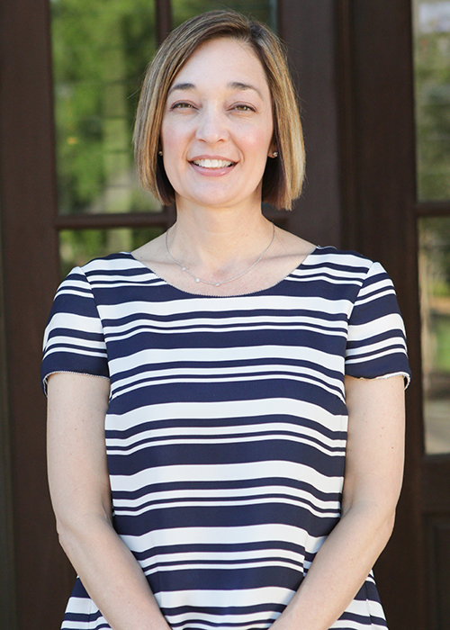 Kelly Moser, pictured in a navy and white striped shirt