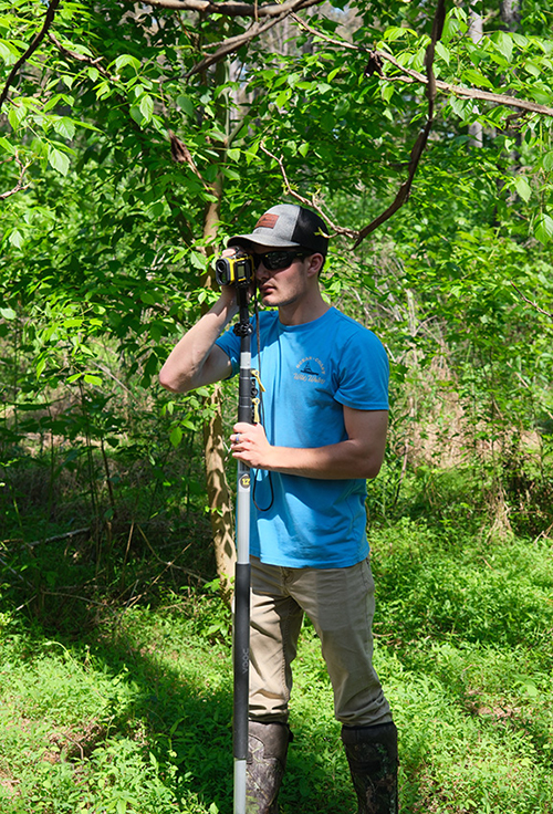 Kennedy Brooks, senior forestry major from Laurel, uses a laser hypsometer to measure tree height. (Submitted photo) 