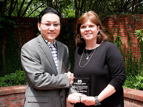 Sang Joon Lee, left, assistant professor in Mississippi State’s Department of Instructional Systems and Workforce Development, receives the inaugural Online Teaching Award from Susan Seal, MSU Center for Distance Education executive director. (Photo submitted)