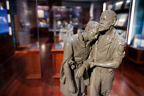 The Wounded Scout: A Friend in the Swamp is an 1864 sculpture included in the exhibit titled “John Rogers: The People’s Sculptor,” part of the Frank and Virginia Williams Collection of Lincolniana at MSU’s Mitchell Memorial Library. The piece, which depicts an escaped slave leading and protecting a wounded soldier, was at one time presented by Rogers as a gift to President Abraham Lincoln. (Photo by Megan Bean)