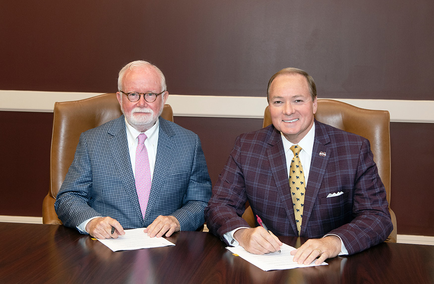 Luckyday Foundation Board Chairman Holmes S. Adams, left, and MSU President Mark E. Keenum signed a memorandum of agreement earlier this month, establishing MSU’s inaugural Luckyday scholarship awards. (Photo by Beth Wynn) 