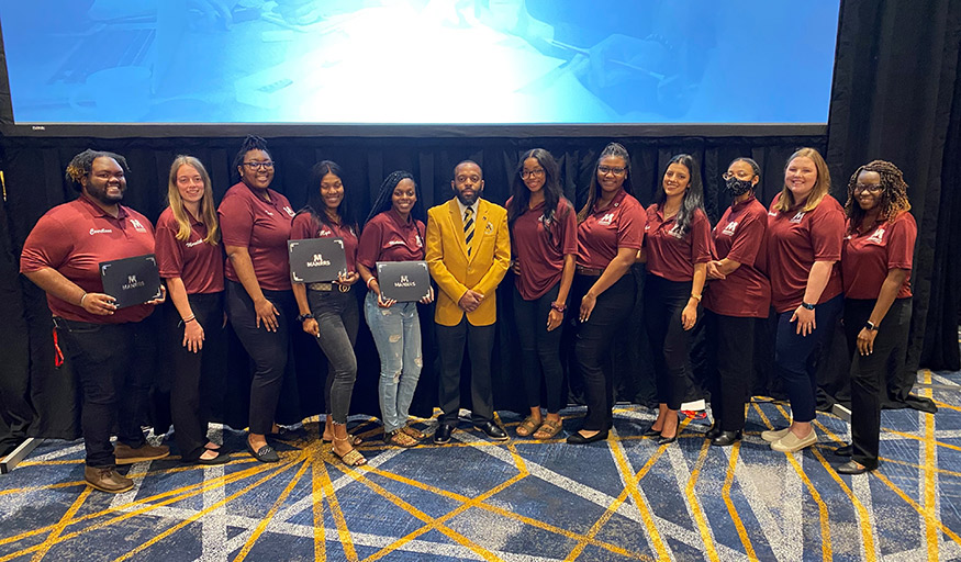 MSU MANRRS Co-Advisor and Associate Professor Derris Devost-Burnett, center, is pictured with several MSU student members of MANRRS attending a conference.