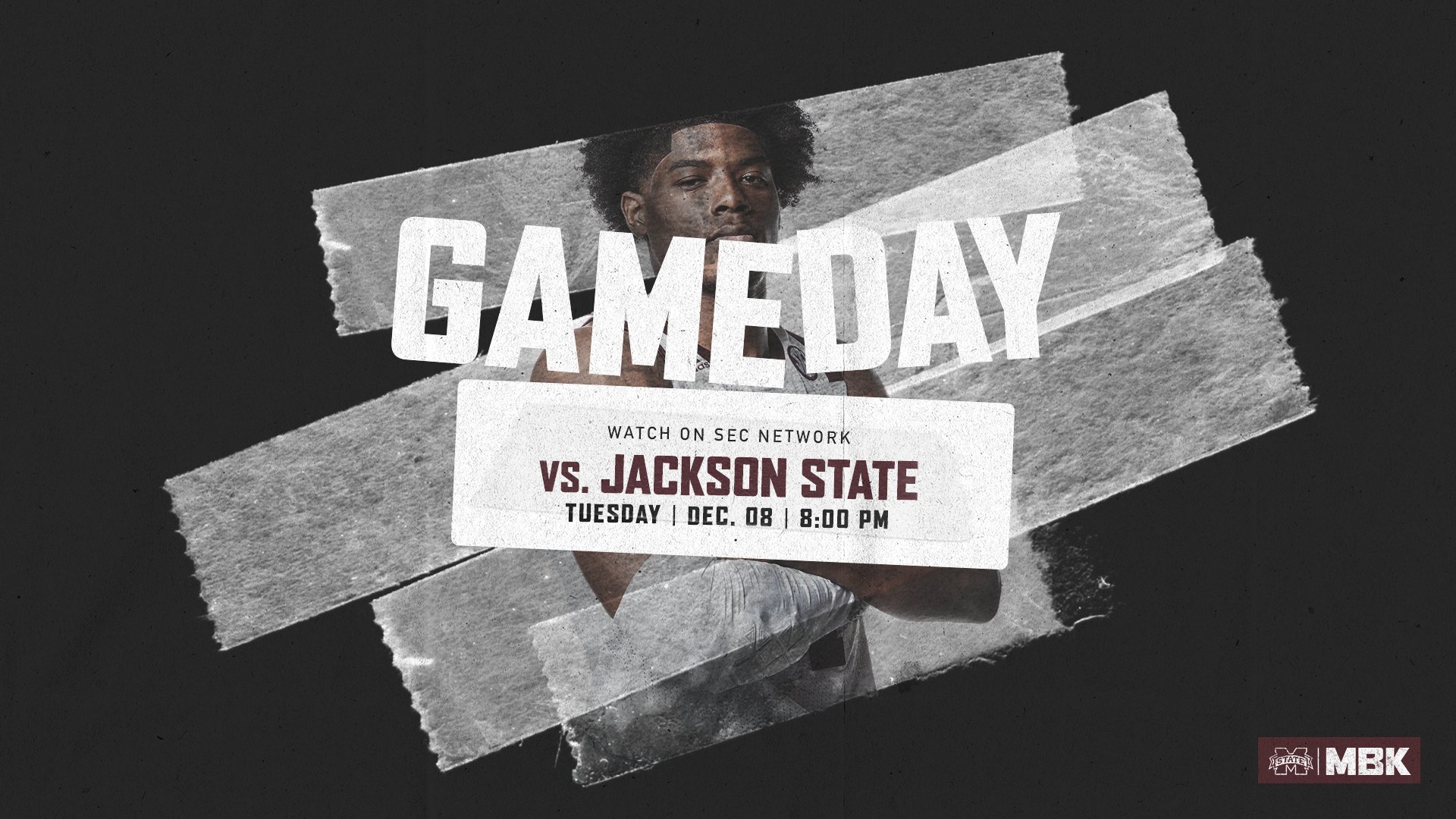 Image of a Mississippi State basketball player staring at the camera while folding his arms across his chest.