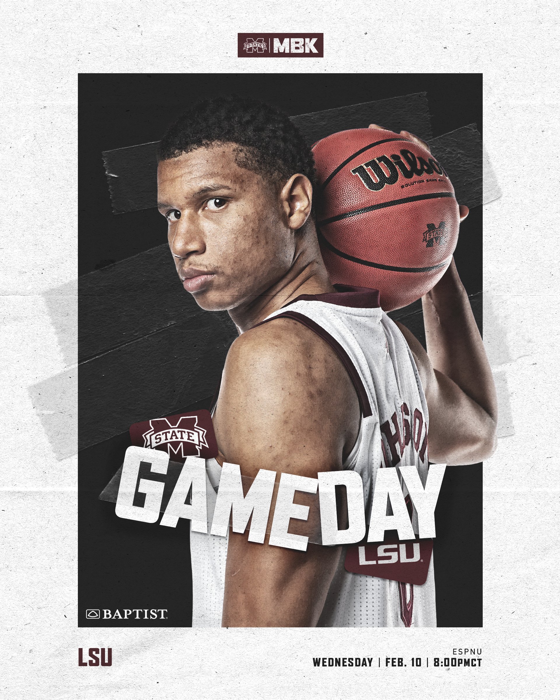 MSU men's basketball player Jalen Johnson stares at the camera while holding an orange Wilson basketball over his right shoulder.