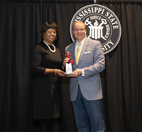MSU President Mark E. Keenum presents an engraved cowbell to Camille Scales Young, keynote speaker for the university’s 30th annual Dr. Martin Luther King Jr. Unity Breakfast on Monday [Jan. 15]. 