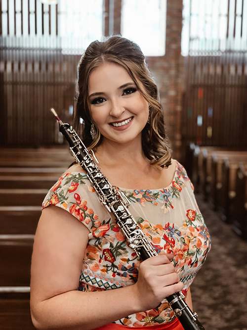 Portrait of Madeline Lee with her oboe