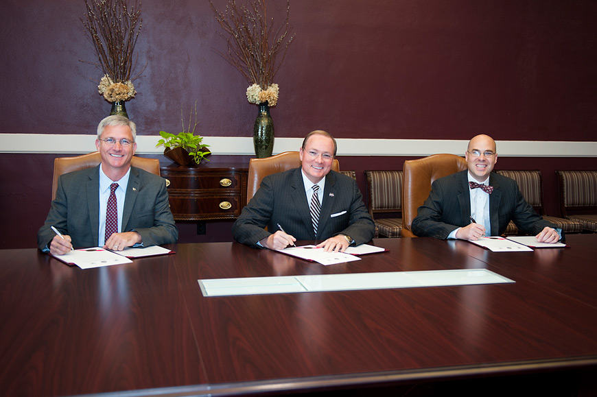 Northern District Transportation Commissioner Mike Tagert (l-r), MSU President Mark E. Keenum, and Starkville Mayor Parker Wiseman participated in a signing ceremony Thursday [Oct. 22] to declare their commitment to the improvement of Highway 12. (Photo by Russ Houston)