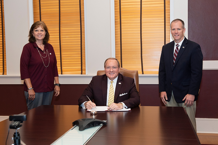 Susan Seal, Mark Keenum and John Dickerson are pictured signing an MOU in the president's conference room