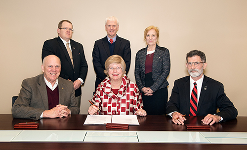 Signing a cooperative agreement Feb. 7 to train workforce entrants for Nebraska’s poultry industry are, front row, left-right, George Hopper, dean of MSU’s College of Agriculture and Life Sciences; Judy Bonner, MSU provost and executive vice president; and Ron Rosati, dean of the Nebraska College of Technical Agriculture; back row, left-right are Doug Smith, Nebraska College of Technical Agriculture chair of Animal Science and Agricultural Education; Peter Ryan, MSU associate provost for academic affairs; and Mary Beck, MSU professor and head of the university’s Department of Poultry Science. (Photo by Beth Wynn) 