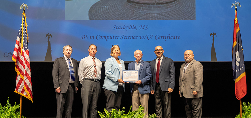 MSU is presented with a plaque recognizing its Center of Academic Excellence in cyber defense designation.
