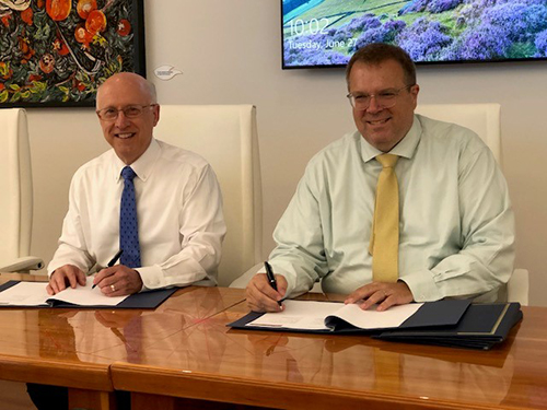 David Shaw and John Lackey sign a memorandum of understanding.
