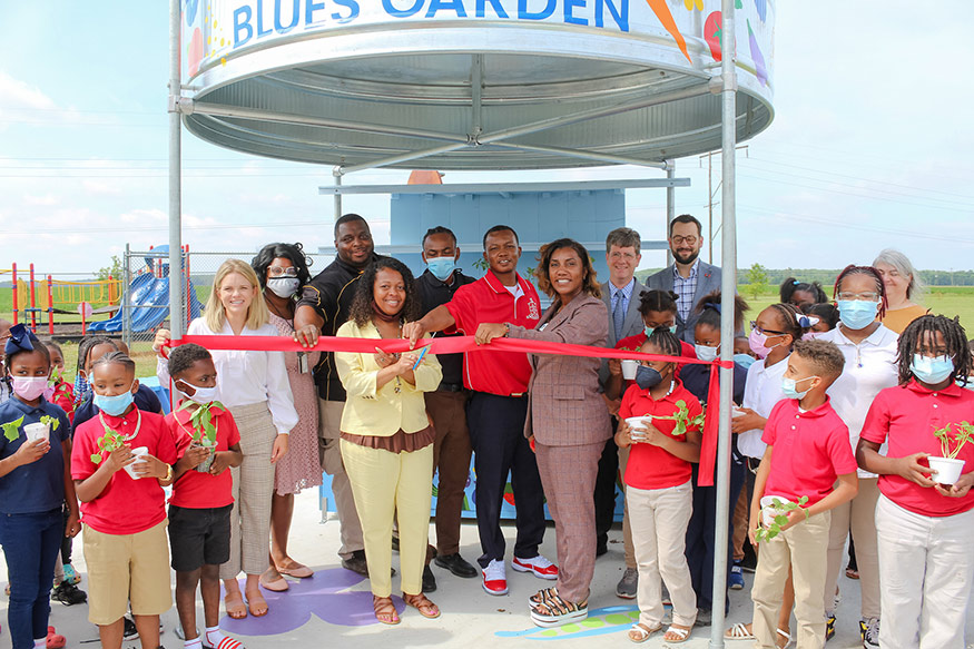 Leflore County Elementary School Principal April Smith cuts the ribbon as students and other leaders from the local area and Mississippi State University look on during a May 19 ribbon cutting ceremony. 