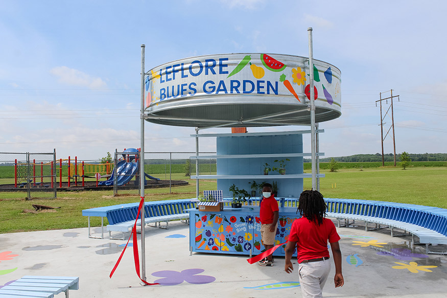 Two elementary students look over the new learning garden area