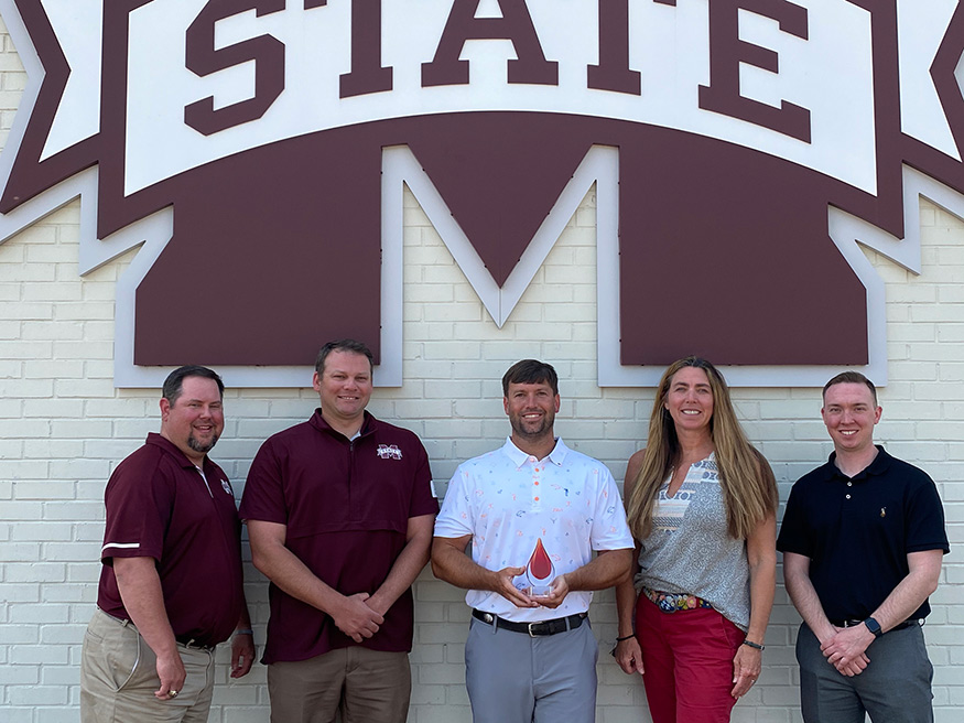 The MSU Athletic Dept. accepts the MBS 2020 Outstanding Achievement Award. Pictured (from left): Alex Sheffield, Jeremy Ward, Justin Sendelweck, Ann Brett Strickland and Tyler Downs.