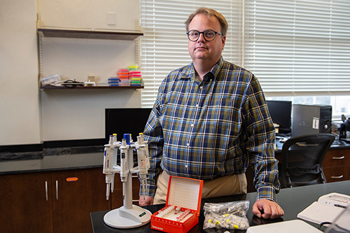 Mark Welch stands in his research laboratory.