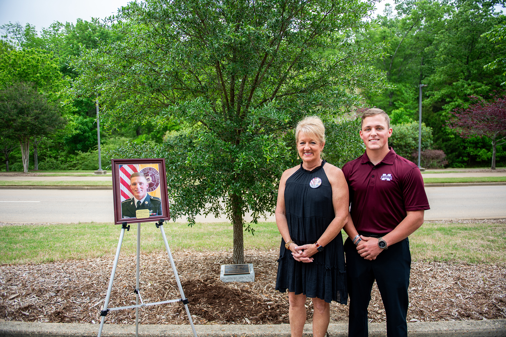 Christy and Cade Marlow pictured with the memorial tree dedicated to Cadet Colby Marlow