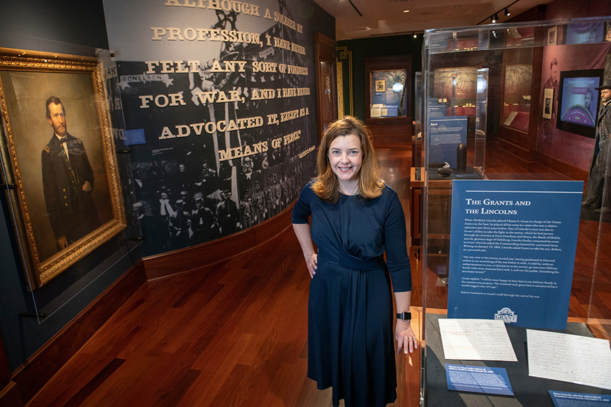 Anne Marshall is wearing a blue dress and pictured in the U.S. Grant Presidential Library