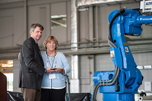 Dennis Smith, director of the MSU Advanced Composites Institute, presents a plaque honoring pioneering NASA scientist Marvin B. Dow to Marvin’s daughter, Heather, during the grand opening of the Marvin B. Dow Stitched Composites Development Center. (Photo