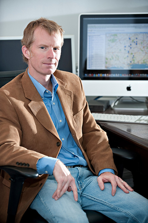 Robert McMillen, pictured seated at his desk