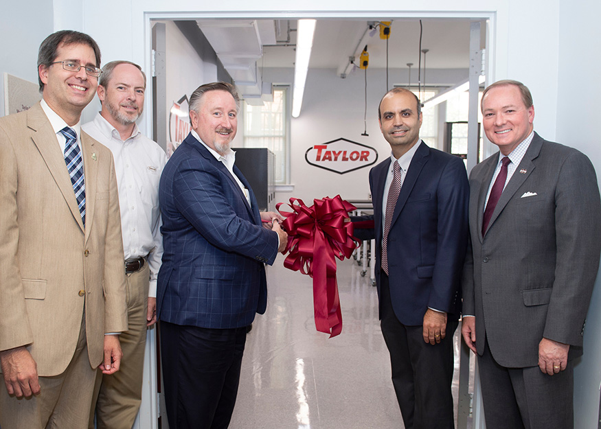 Celebrating a ribbon-cutting ceremony for the new Taylor Solid Mechanics Laboratory at MSU were, from left, Jason Keith, Bagley College of Engineering dean; Matt Hillyer, director of engineering for the Taylor Group who also is an MSU mechanical engineering department advisory board member; Lex Taylor, chairman and CEO of the Taylor Group, Inc.; Pedro Mago, professor and head of mechanical engineering; and MSU President Mark E. Keenum. (Photo by Megan Bean) 