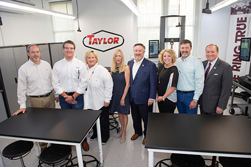 Pictured during a tour of the Taylor Solid Mechanics Laboratory are, from left, Matt Hillyer, director of engineering for the Taylor Group, and Taylor family members Matthew Ktsanes, Teresa Taylor Ktsanes, Margaret Taylor, Lex Taylor, Amanda Taylor, and Robert Taylor, along with MSU President Mark E. Keenum, far right. (Photo by Megan Bean) 
